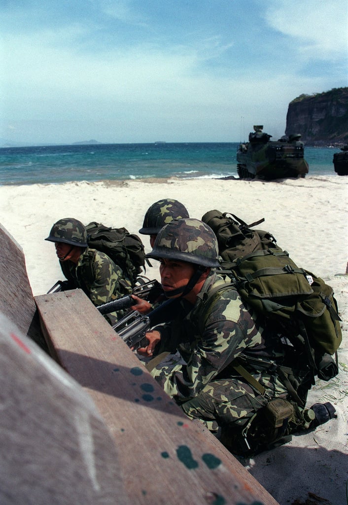 Philippine Marines take up defensive positions on the beach at Marine ...