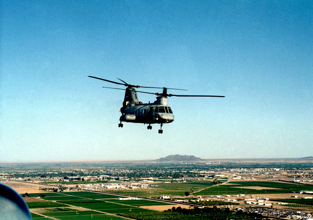 A CH-46 Sea Knight helicopter flys in formation during an exercise