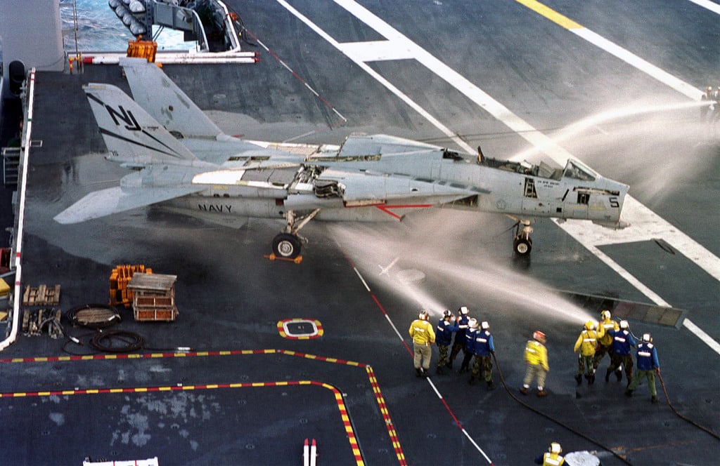 on-the-flight-deck-of-the-uss-enterprise-cvn-65-sailors-employ-techniques-on-an-f-14-tomcat