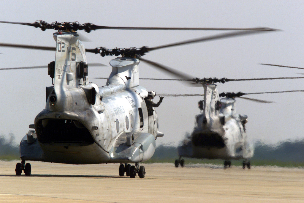 A United States Marine Corps CH-46E Sea Knight crewmember leans