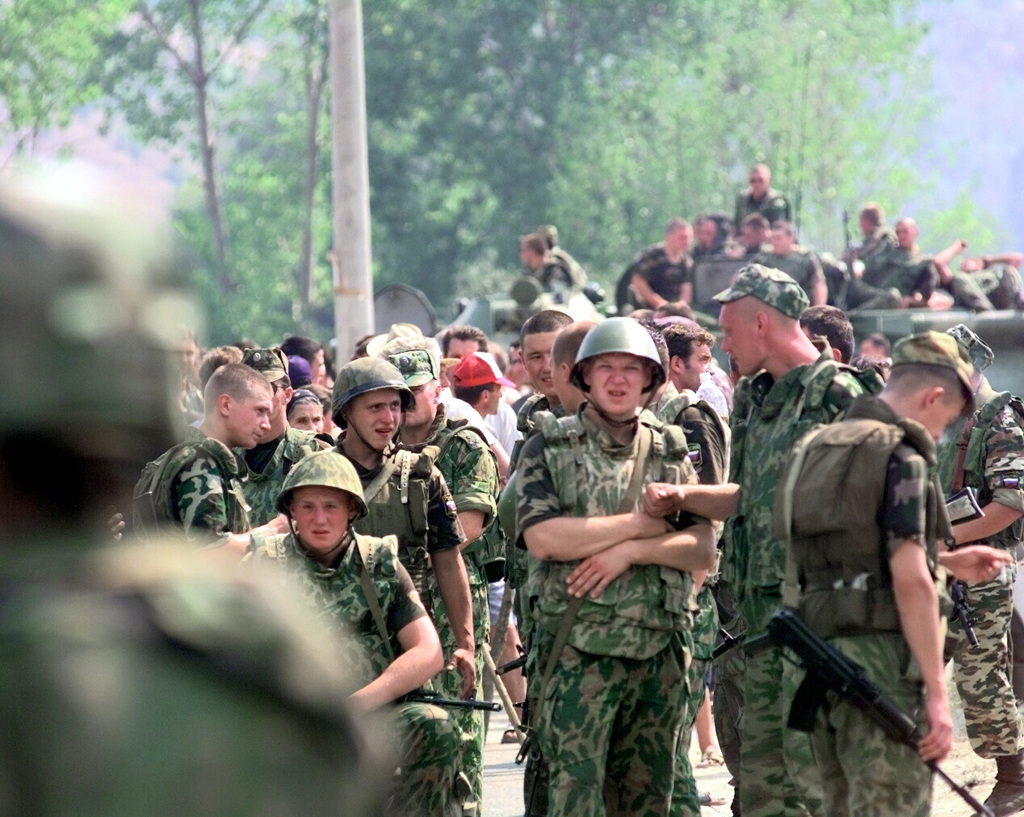 Kosovo Force (KFOR) Russian soldiers stand in front an angry Serbian mob in  the town of Domorovce, Kosovo. The Serbians are protesting the  disappearance of two men from their town. The Serbians