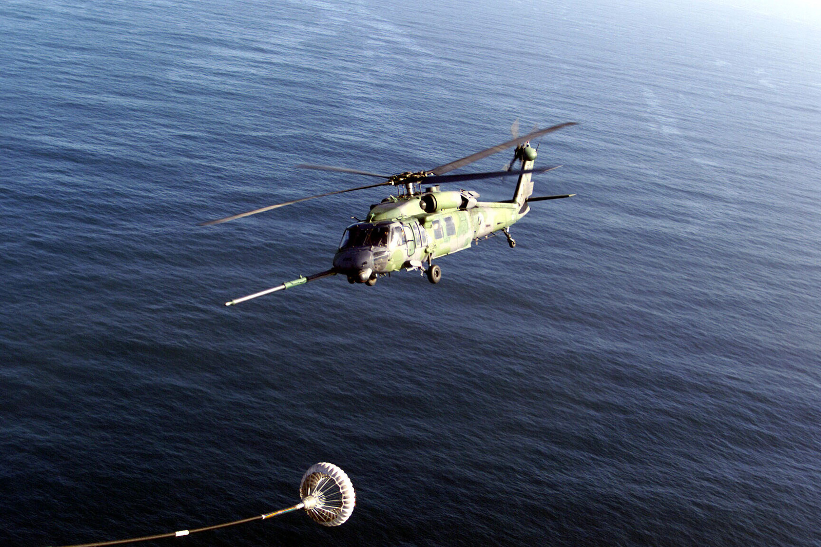 An aerial left side view of an HH-60G Pavehawk helicopter from the ...