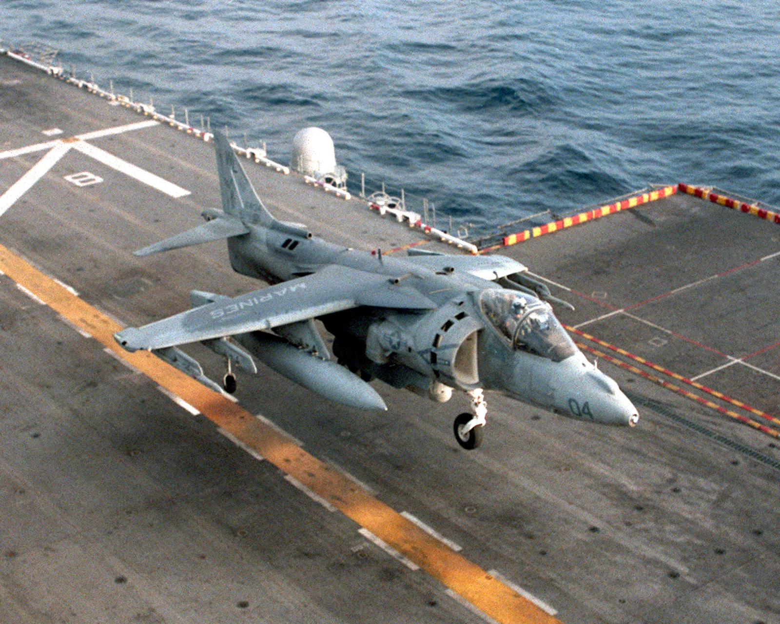 An AV-8B Harrier aircraft lands aboard the USS TARAWA (LHA 1) during ...