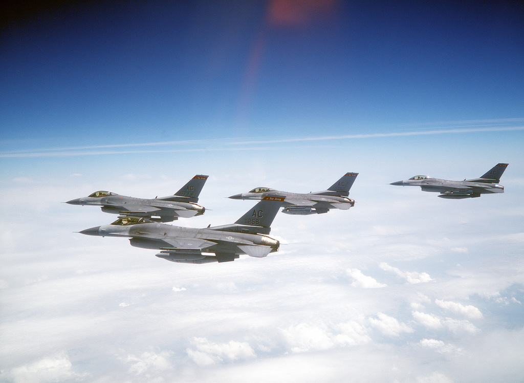 Left side view of four F-16 Fighting Falcon aircraft, armed with AIM-9 ...