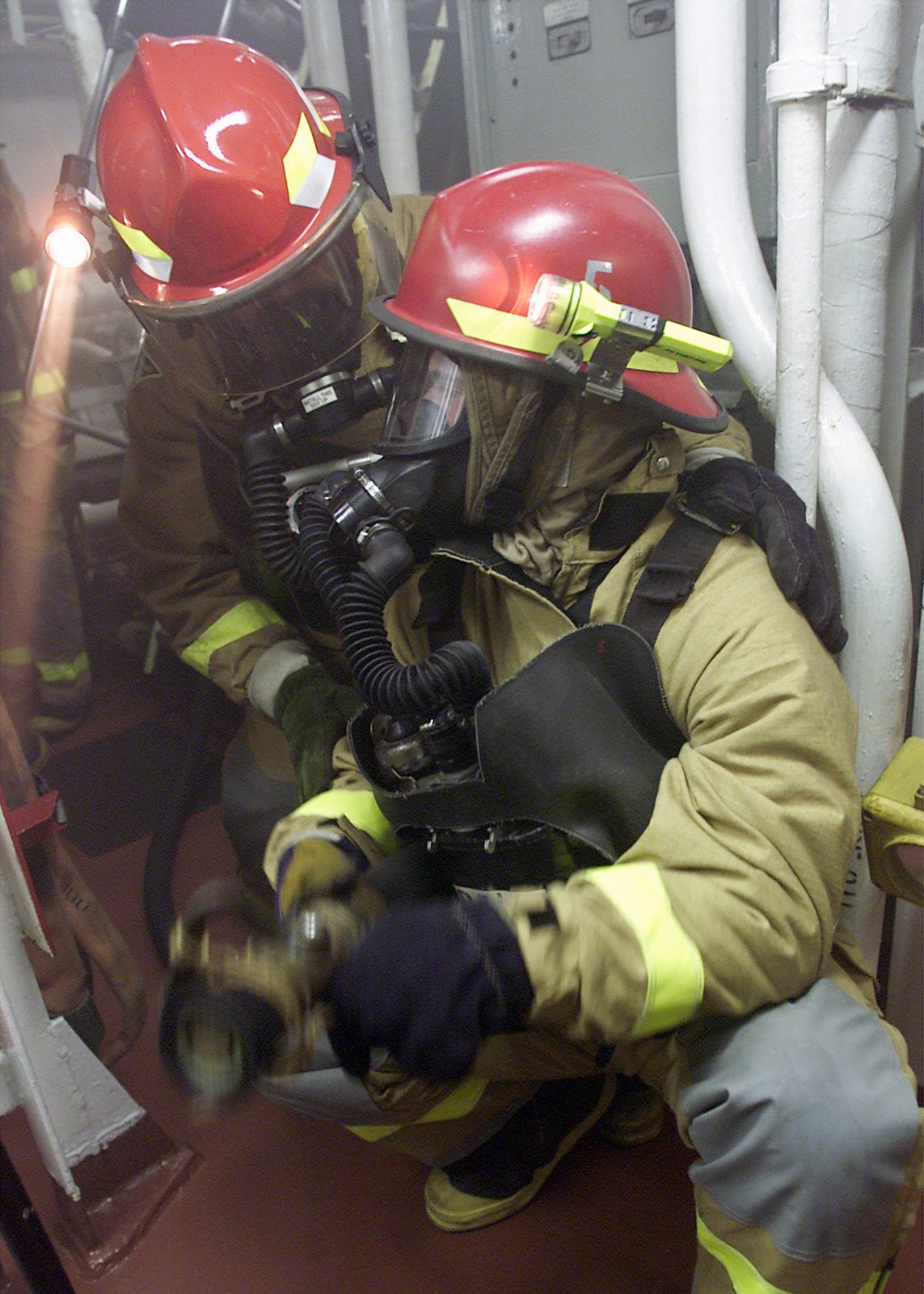 Two Us Navy (usn) Fire Control Technicians (ft) Wearing Fire Suites And 