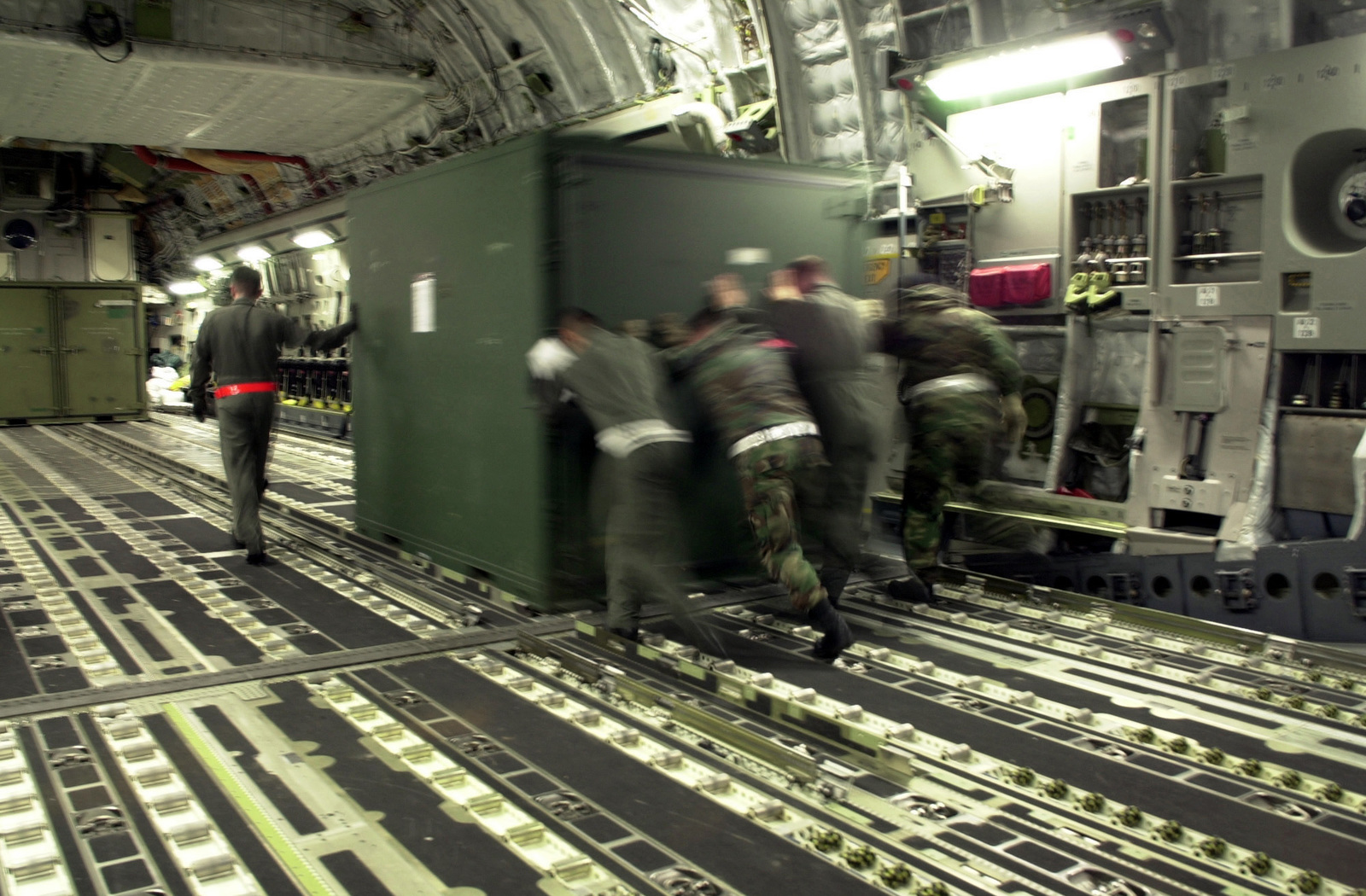 The load crew puts some extra muscle as they push an Internal Airlift or  Helicopter Slingable