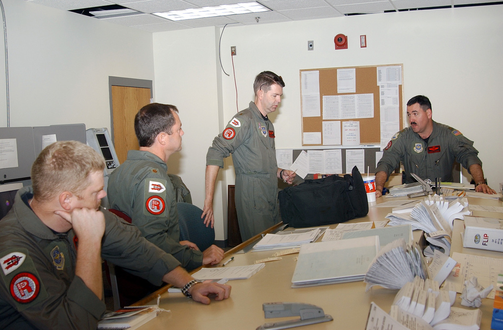 Major Dennis Hayward USAF right Gives A SOF Supervisor Of Flying Brief To Aircrew Members