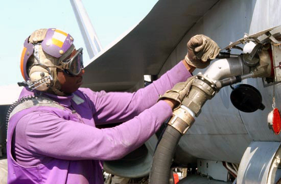 US Navy Engineman 2nd Class Anthony Bartelli (right) holds an