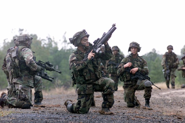 A US Army (USA) 25th Infantry Division (Light) Soldier checks his 5 ...