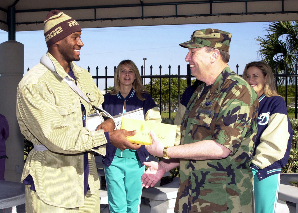 Miami Dolphins Linebacker Derek Rogers presents 100 tickets to Brigadier  General (BGEN) Charles E. Stenner, USAF, US Southern Command, for the Miami  Dolphins playoff game Sunday with the Baltimore Ravens, the defending