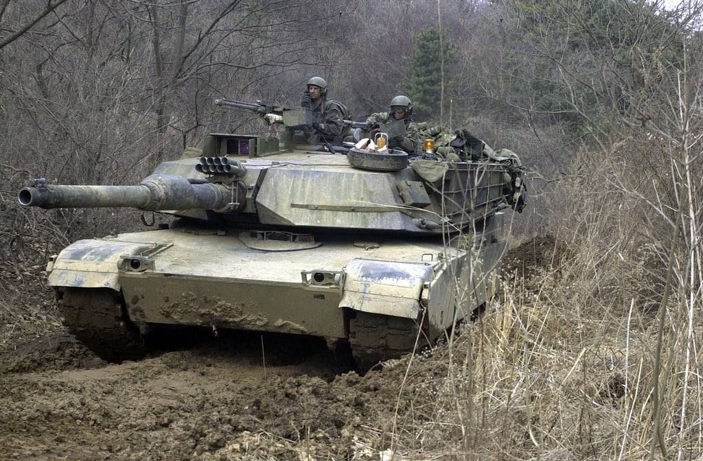 A US Army (USA) M1A1 Abrams Main Battle Tank (MBT) Maneuvers Along The ...