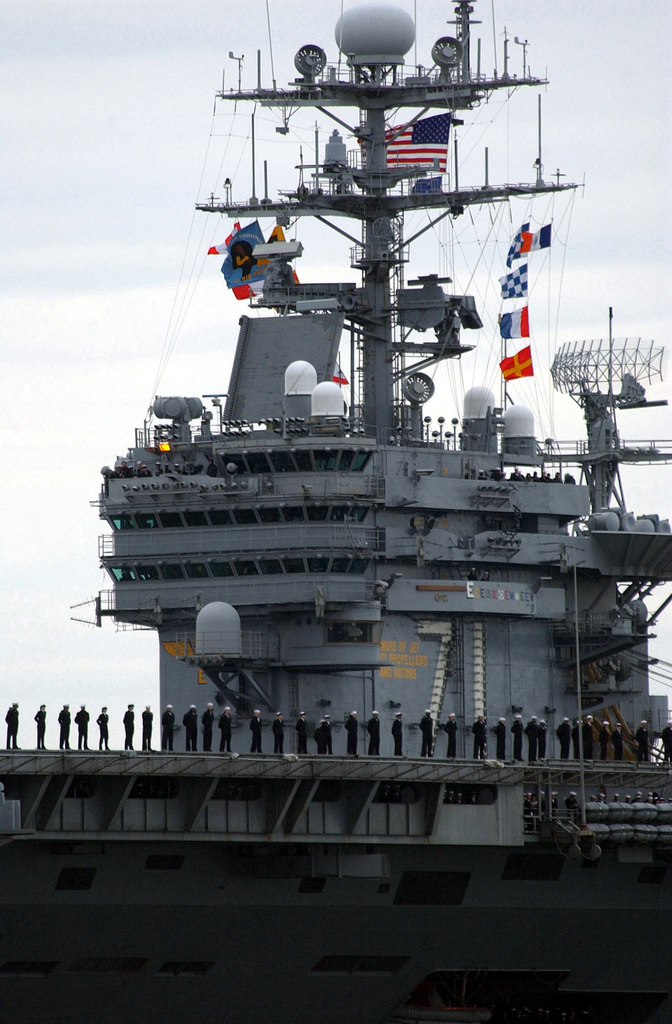 US Navy (USN) Sailors manning the rail of the Aircraft Carrier USS ...