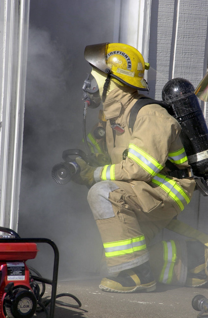 A firefighter, in fire-fighting ensemble (FFE) and INTERSPIRO ...