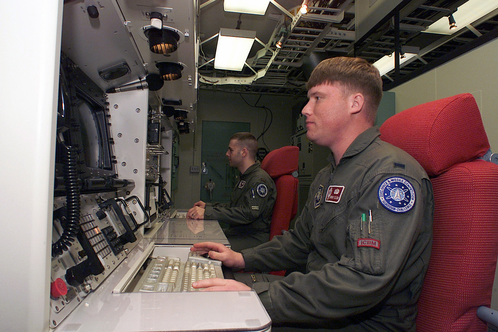 US Air Force (USAF) Lieutenant (LT) Jeremy Olson (foreground) and USAF ...