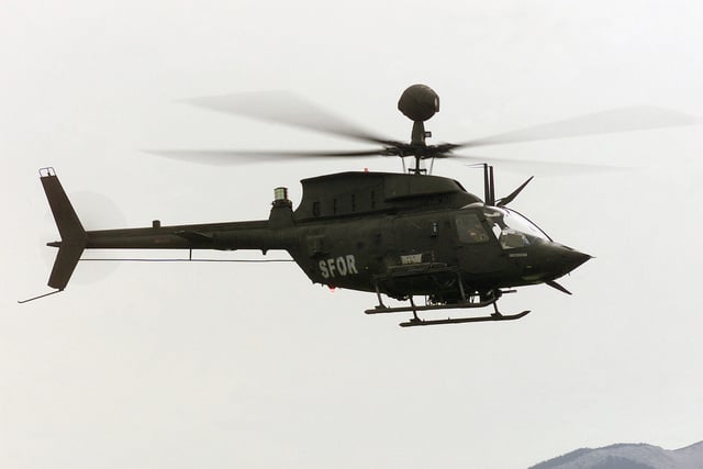 A US Army (USA) OH-58D Kiowa Warrior helicopter flies a close air ...