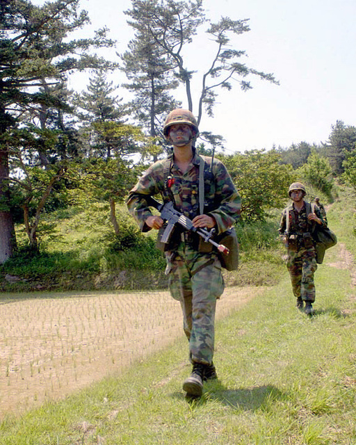 Republic of Korea Marine Corps (ROKMC) Marines, one with a blank firing ...