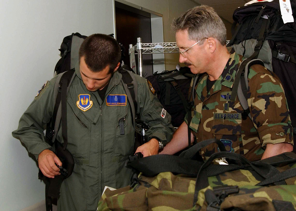 US Air Force (USAF) STAFF Sergeant (SSGT) Scott Humphries (left) gets ...