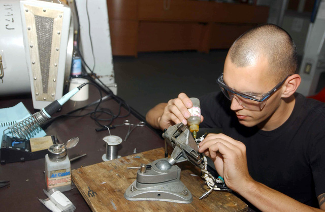 Production. B-25 bombers. Soldering an end fitting to a ...