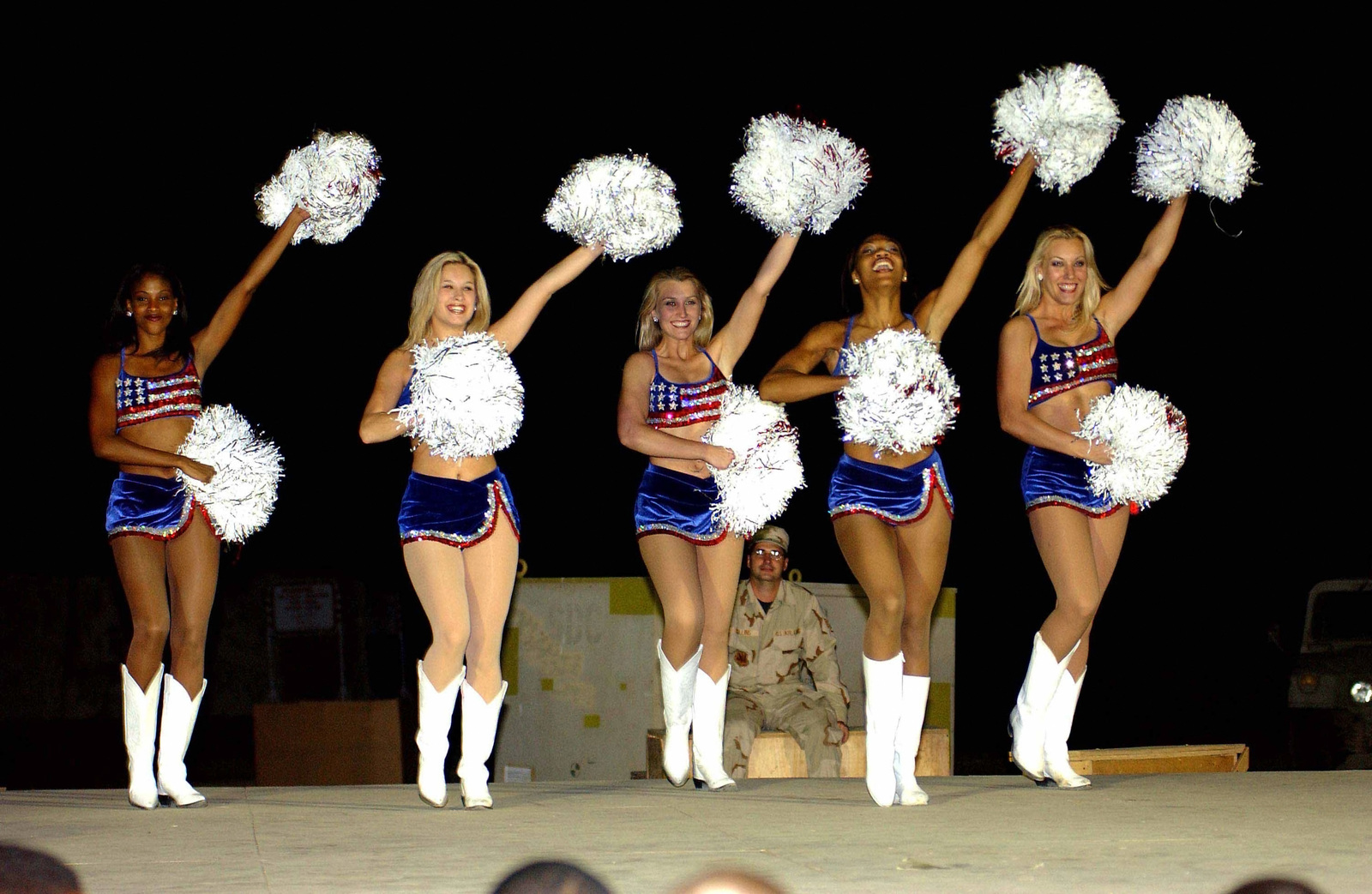The Washington Redskins Cheerleaders and Wizards Dancers combine to perform  a variety show for the deployed members of the 438th Air Expeditionary  Group (AEG) at a forward-deployed location during Operation ENDURING  FREEDOM.