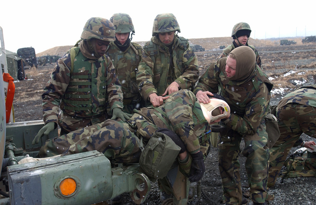 During a casualty drill (left to right) US Navy (USN) Hospital Corpsman ...