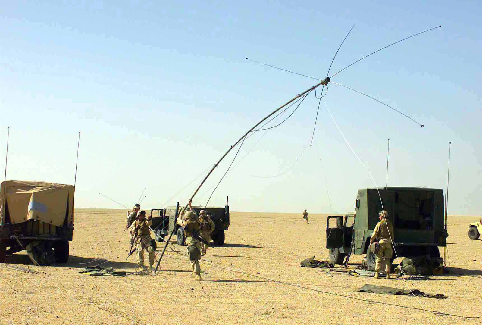 A US Marine Corps (USMC) Radio Platoon (RP) sets up antennas for the ...