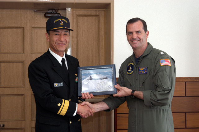 Capt. David Schappert, left, commander of Submarine Squadron 15, observes  the Japan Maritime Self-Defense Force submarine JS Soryu (SS-501) as it  arrives in Apra Harbor, Guam, for a port visit. - PICRYL 