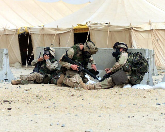 US Marine Corps (USMC) troops don and clear their M40 field protective ...