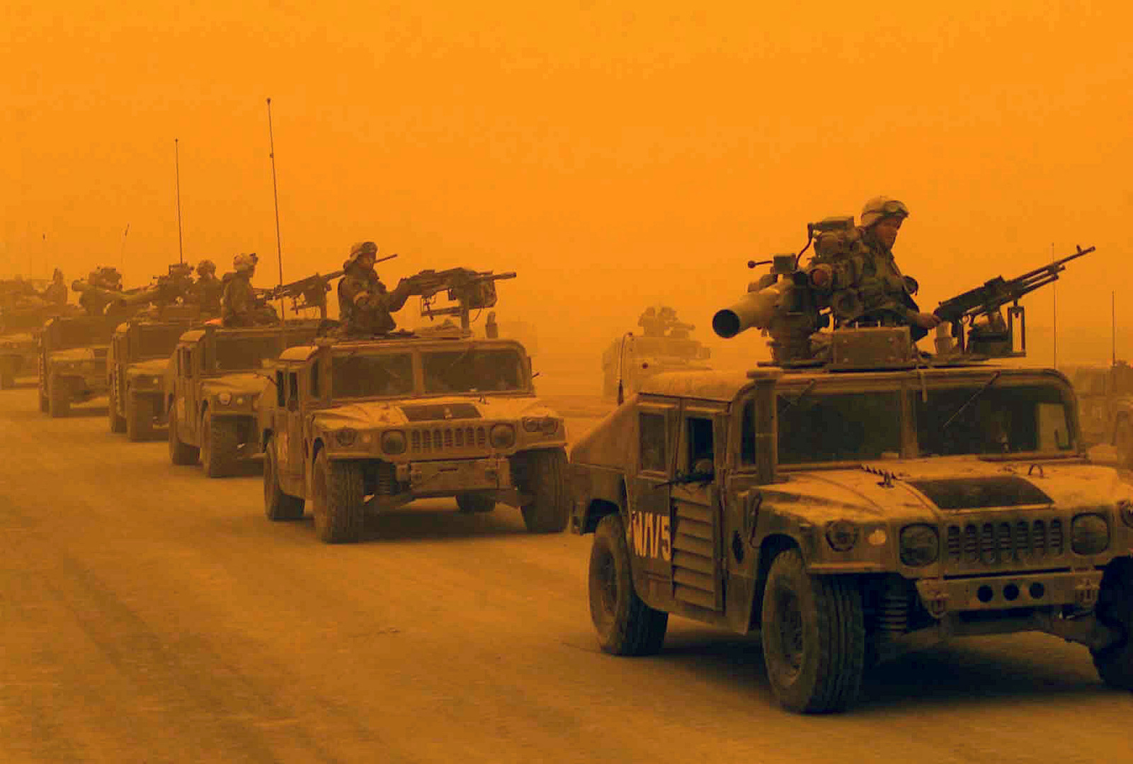 A convoy of US Marine Corps (USMC) High-Mobility Multipurpose Wheeled Vehicles (HMMVW), assigned to D/Company, 1ST Light Armored Reconnaissance Battalion, 1ST Marines Division, arrives in Northern Iraq, during a sandstorm. USMC personnel are in Iraq in support of Operation IRAQI FREEDOM. Several vehicles are equipped with Tube-launched Optically-tracked Wire-guided (TOW) missile launchers