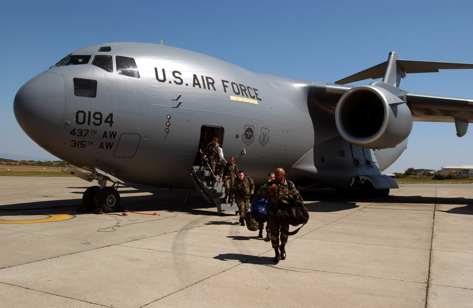 US Air Force (USAF) Airmen offload from a C-17A Globemaster III from ...