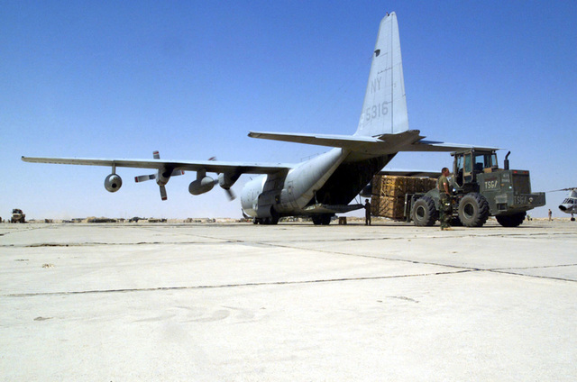 US Marine Corps (USMC) Marines use a rough terrain forklift to load ...