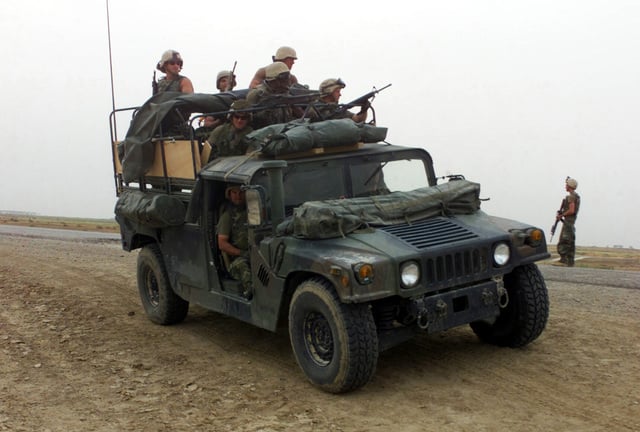 A heavily armed group of US Marine Corps (USMC) Marines assigned to ...