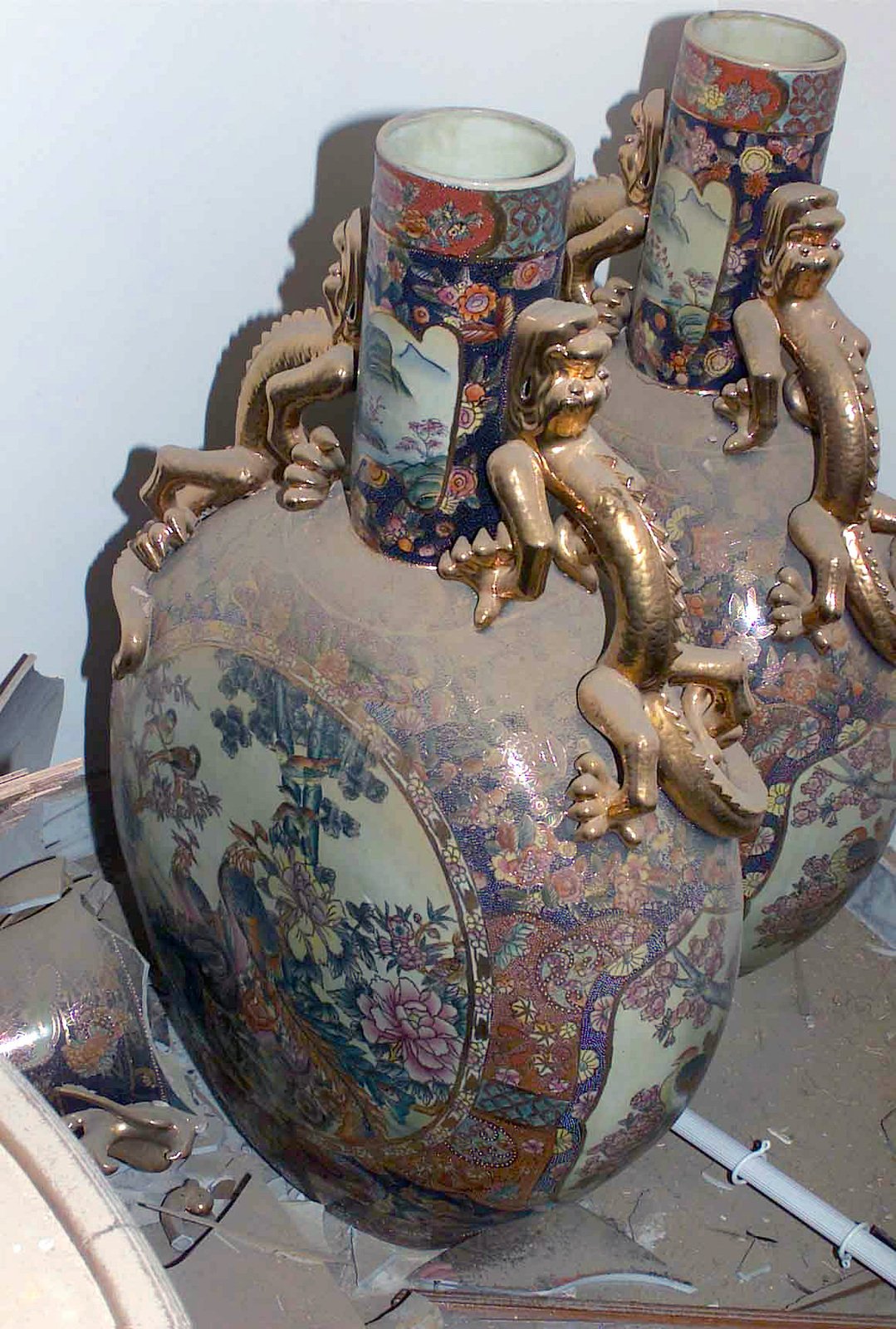 A Pair Of Ornate Chinese Like Vases With Golden Dragon Figurines