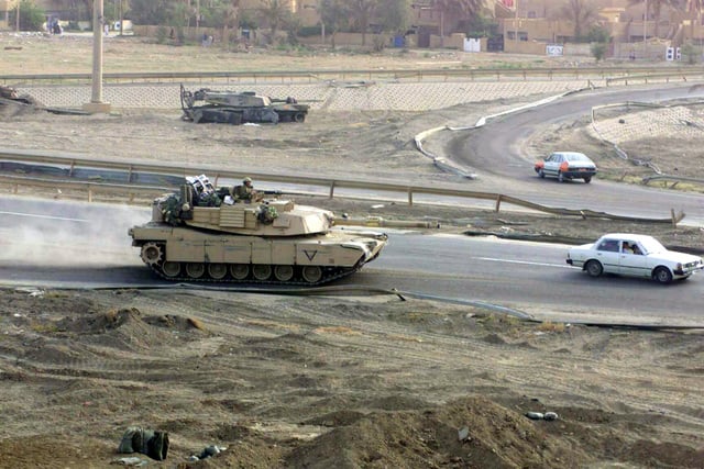 A US Marine Corps (USMC) M1A1 Abrams Main Battle Tank (MBT) merges onto ...