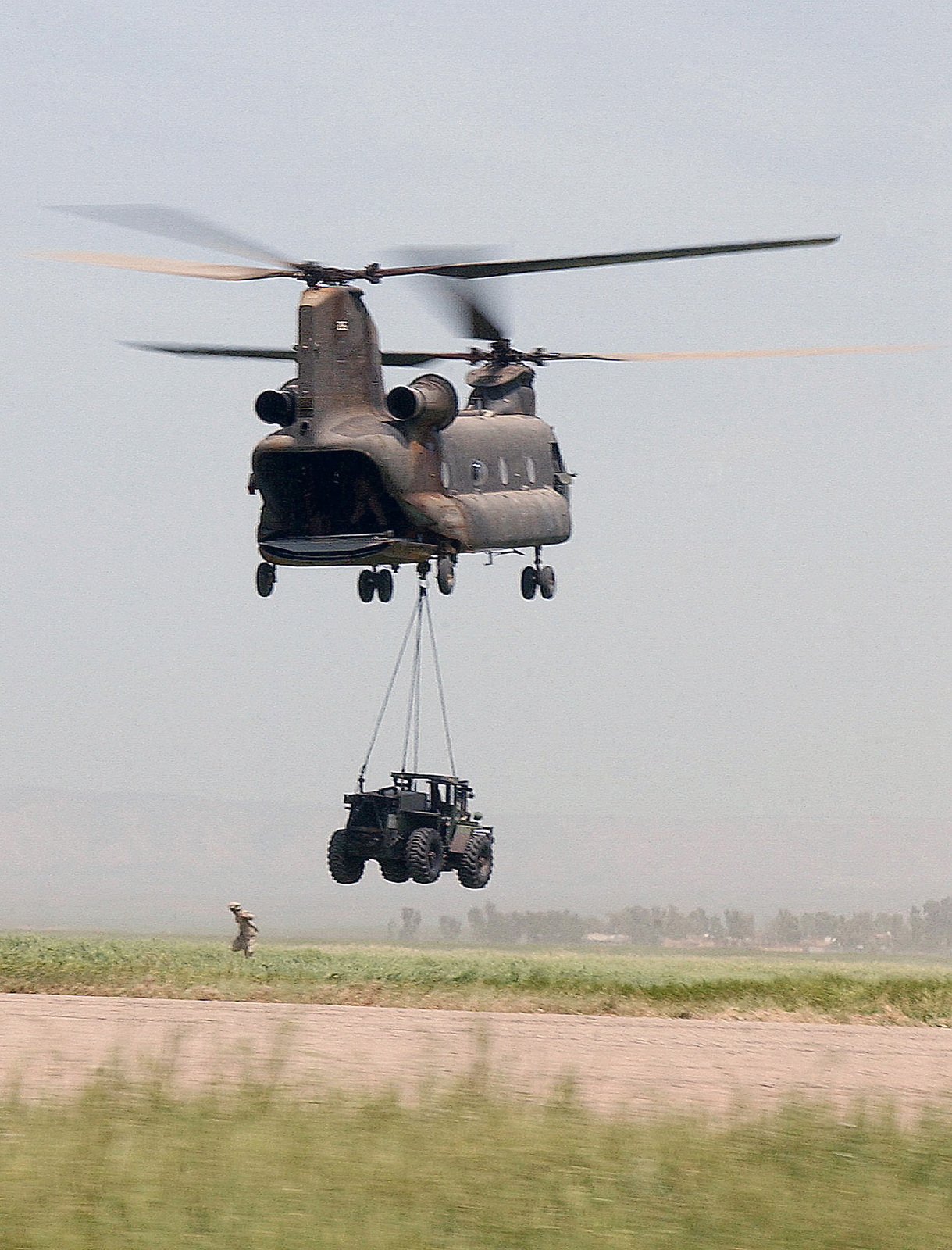 A US Army (USA) CH-47 Chinook helicopter performs a sling load carrying ...