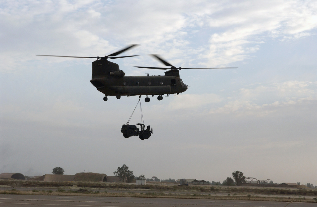 A US Army (USA) CH-47 Chinook helicopter performs a sling load carrying ...