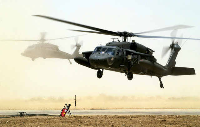 Two US Army (USA) HH-60 Black Hawk helicopters land at a Forward Area ...