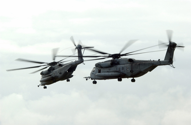 Two US Marine Corps (USMC) CH-53E Super Stallion helicopters take off ...