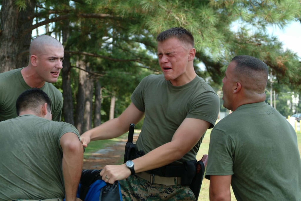 US Marine Corps (USMC) Private First Class (PFC) Michael Moll (center ...