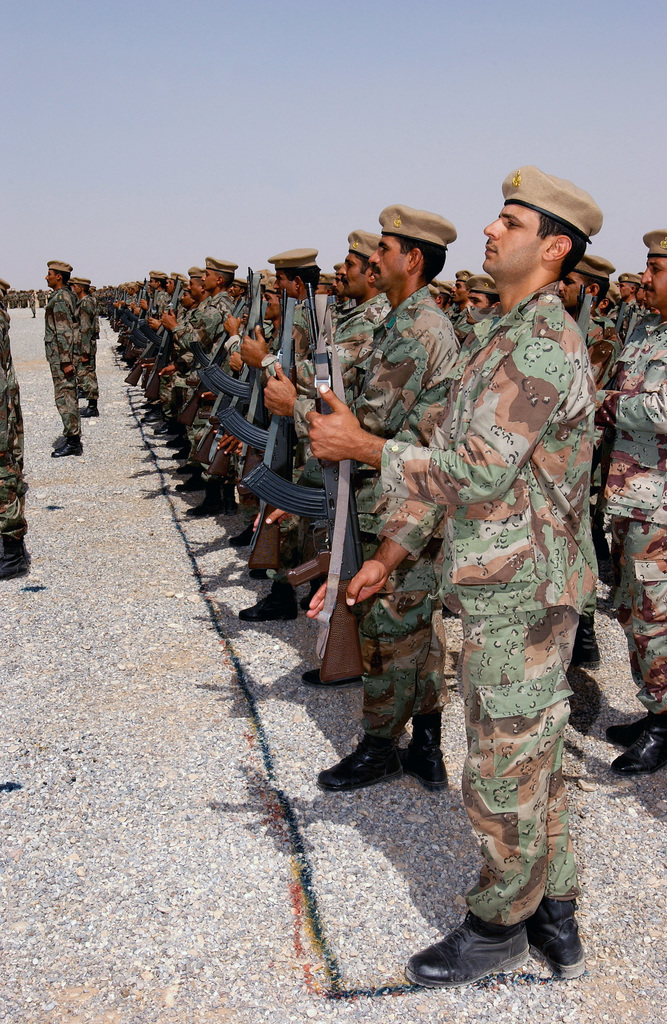 New Iraqi Army (NIA) recruits present their arms in formation prior to ...