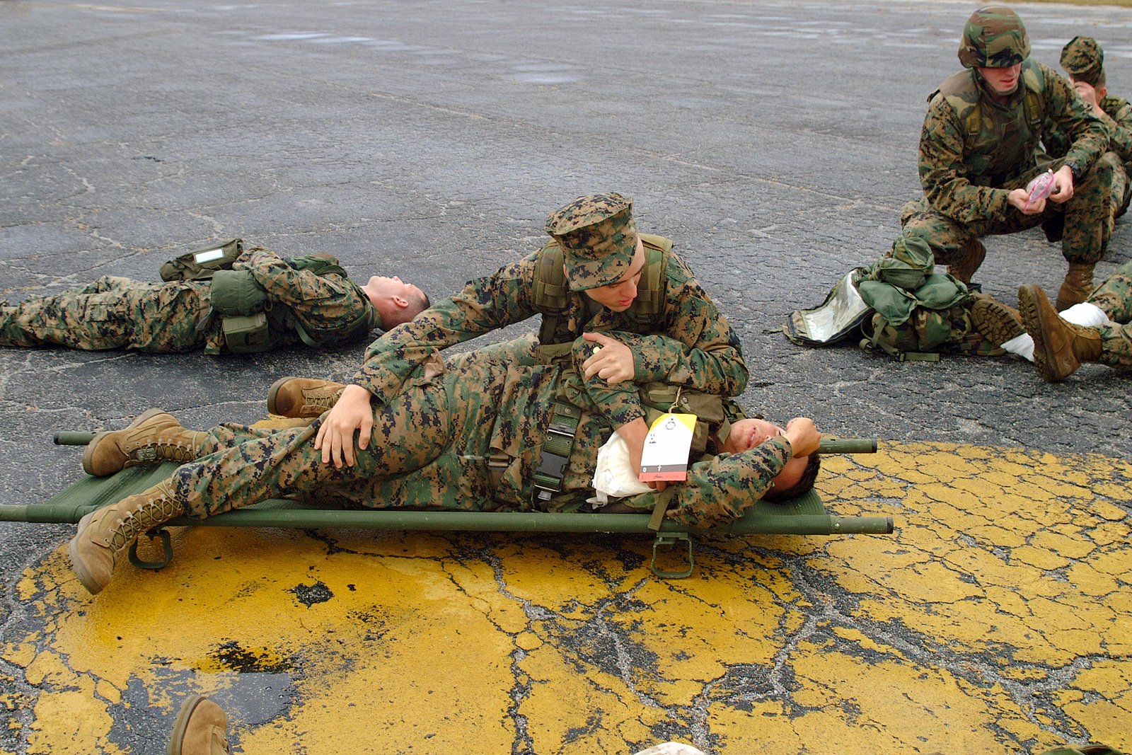 US Navy (USN) Corpsmen and US Marine Corps (USMC) Marines assigned to ...