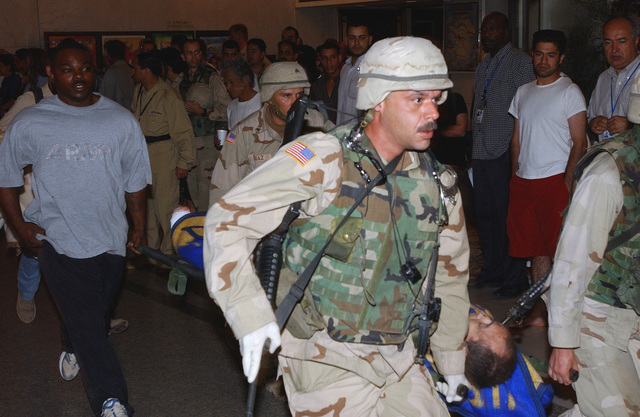 A US Army (USA) soldier a stretcher through the Al Rashid hotel in ...