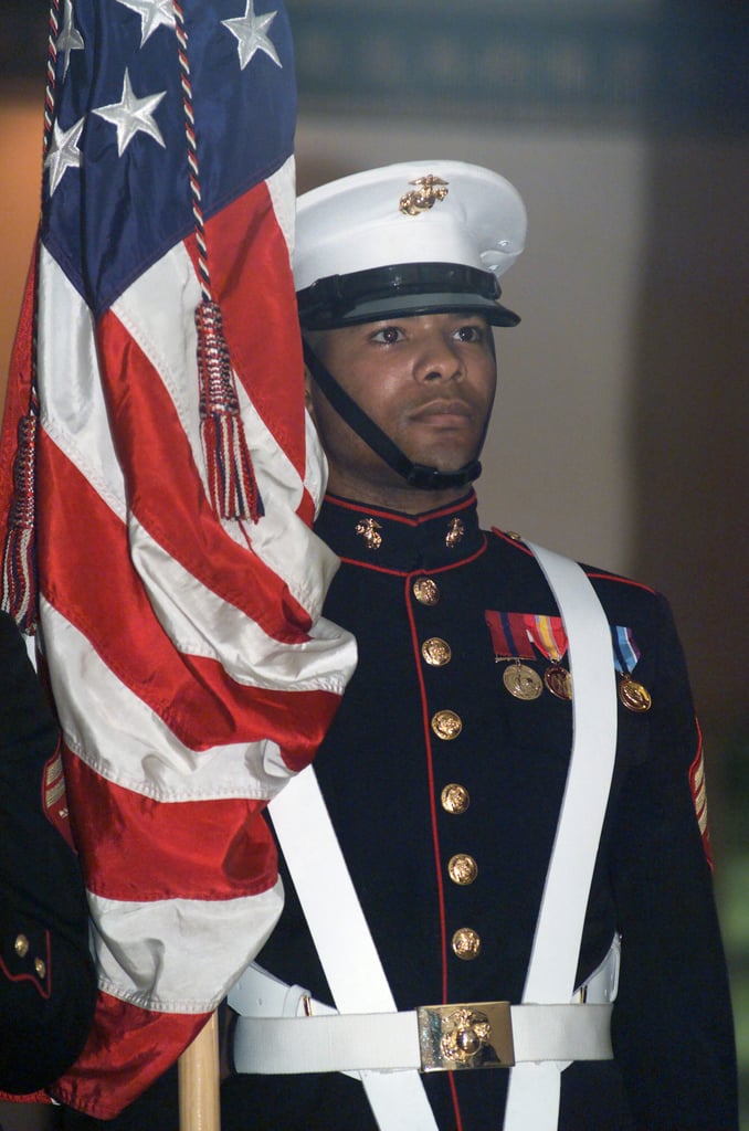 A US Marine Corps (USMC) Color Guard Sergeant (SGT) holds the American ...