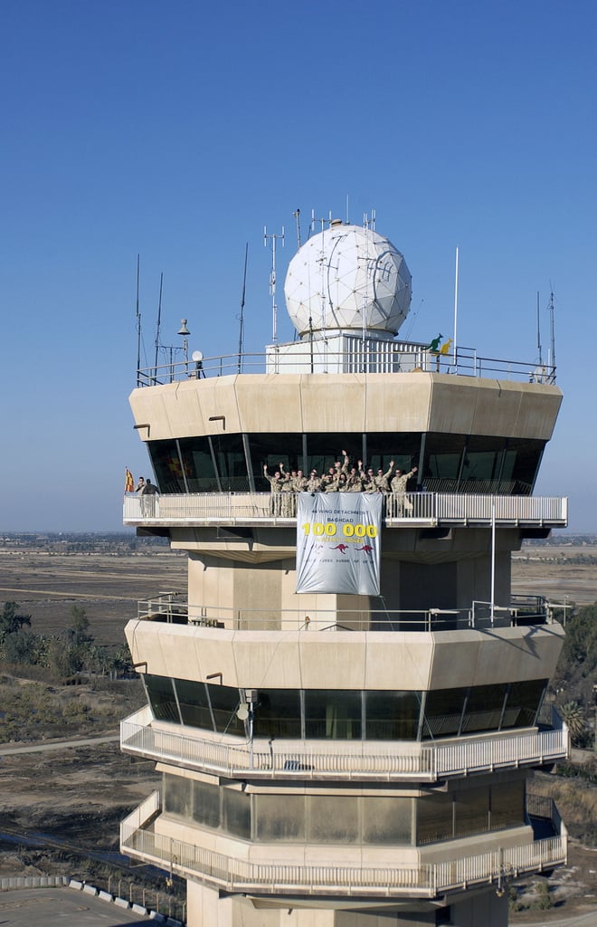 Austrailian military personnel from the Australian Air Control Tower  Detachmet, Task Unit 633.4.2 celebrate the One Hundred Thousand aircraft to  move through Baghdad International Airport (BIA), Iraq, in support of  Operation IRAQI