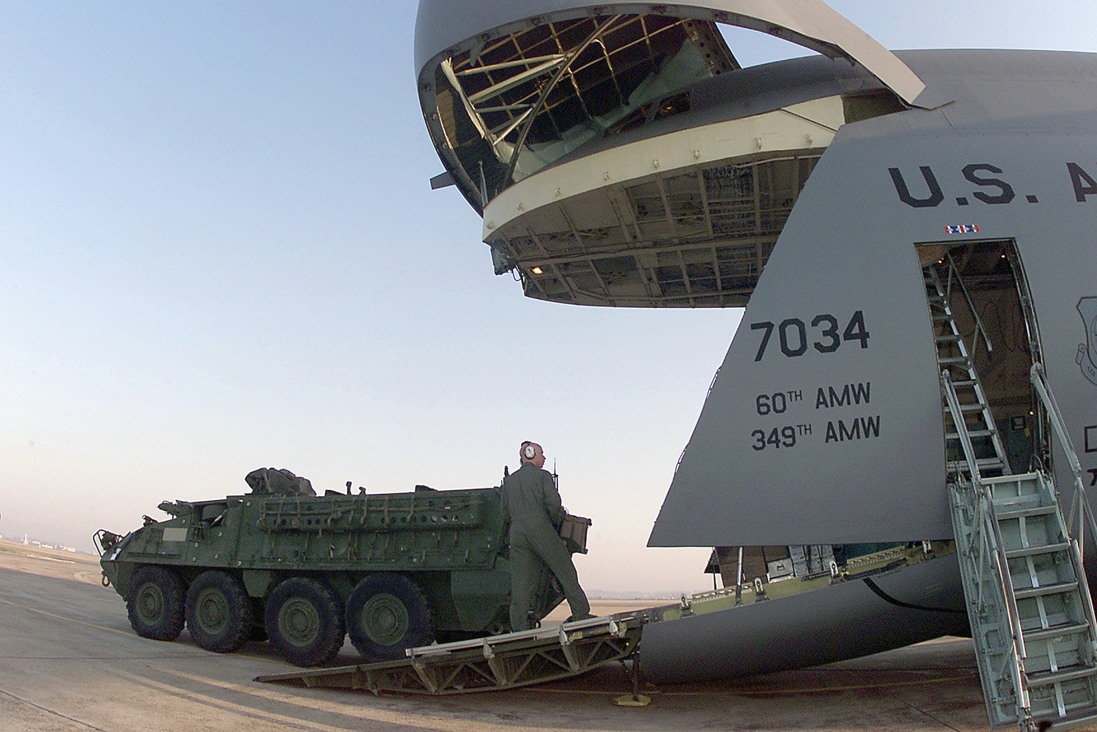 A US Air Force (USAF) Loadmaster guides a US Army (USA) M1126 Stryker ...