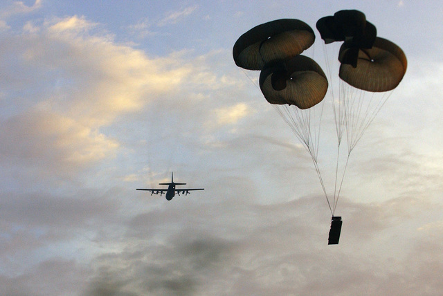 A US Air Force (USAF) C-130 Hercules cargo aircraft drops an M198 Towed ...