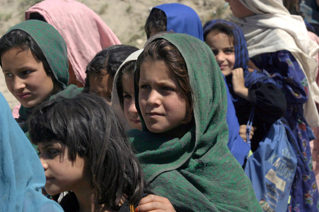 Afghan girls from the Surobi Girls School wait in line as US Marine ...