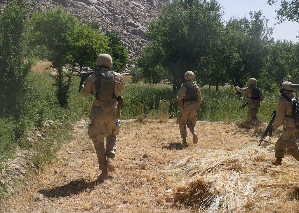 Under intense enemy fire, US Marine Corps (USMC) personnel from ...