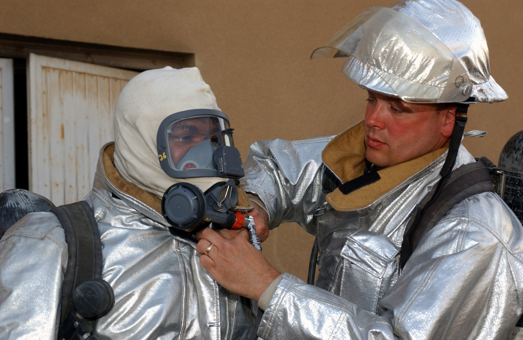 US Air Force (USAF) MASTER Sergeant (MSGT) Roddie PETTY (right) assists ...