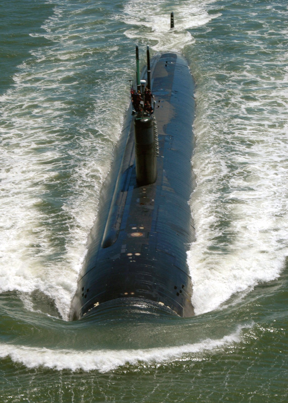 High oblique bow on view showing US Navy (USN) Sailors manning a ...