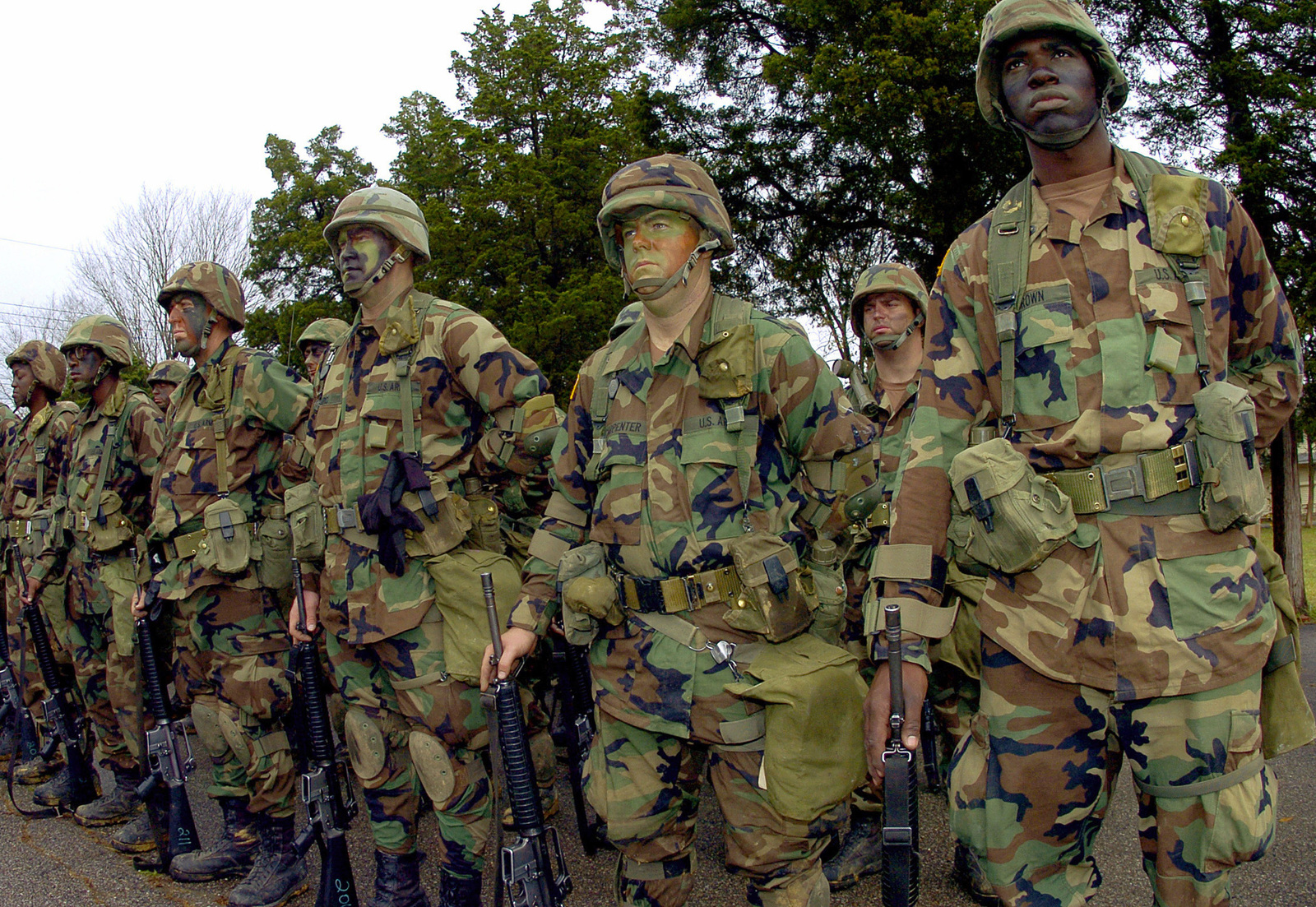 Prior U.S. Air Force Airmen and U.S. Navy Sailors stand in formation